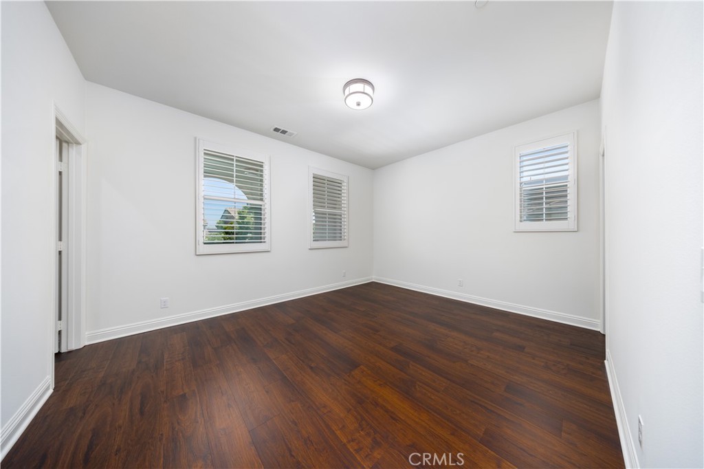 130 Yellow Daisy Irvine, CA 92618 - Photo 27 of 48 an empty room with wooden floor and windows