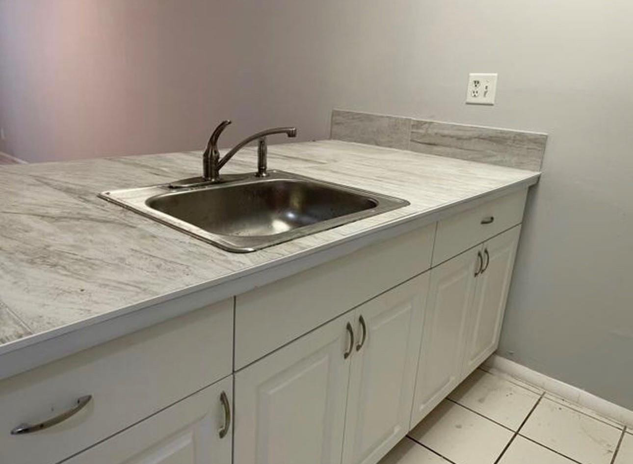 2701 Riverside Drive, Unit 107B Coral Springs, FL 33065 - Photo 3 of 13 a close view of sink and tap