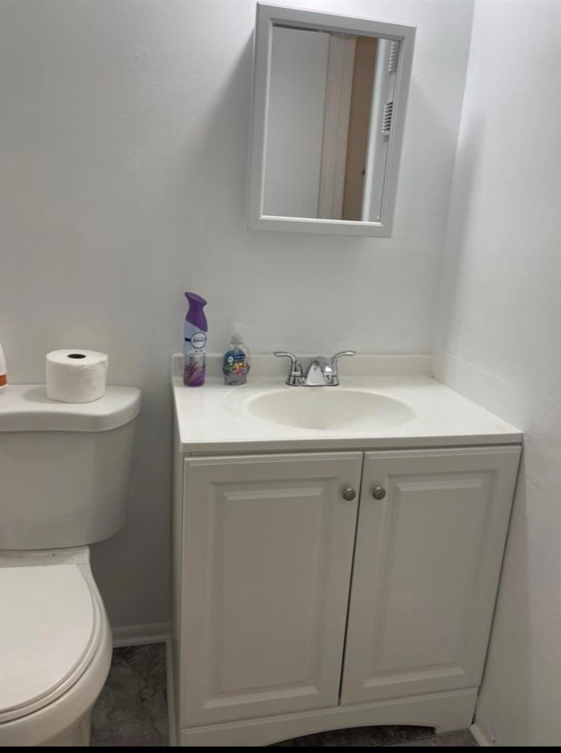 2701 Riverside Drive, Unit 107B Coral Springs, FL 33065 - Photo 9 of 13 a bathroom with a toilet sink and mirror