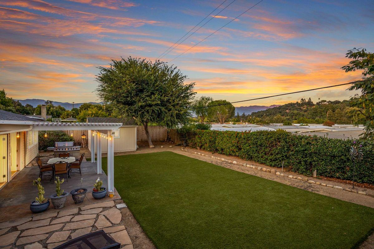 2230 South Rice Road Ojai, CA 93023 - Photo 22 of 26 a view of a patio with table and chairs potted plants with wooden floor and lake view