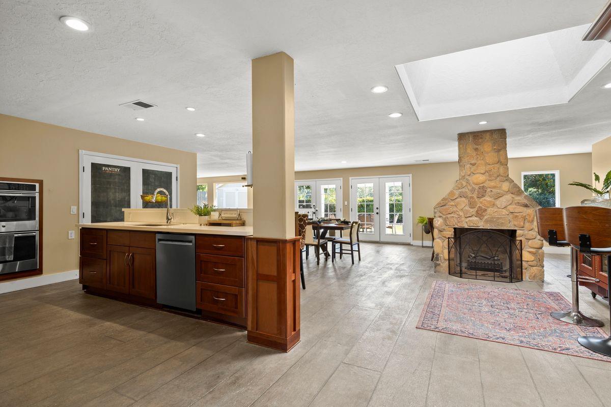 2230 South Rice Road Ojai, CA 93023 - Photo 3 of 26 a living room with furniture a fireplace and a open kitchen view