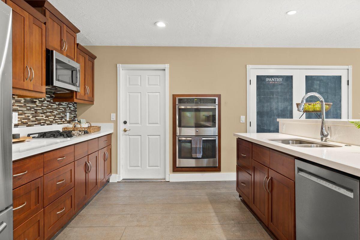 2230 South Rice Road Ojai, CA 93023 - Photo 5 of 26 a kitchen with stainless steel appliances granite countertop a sink and stove top oven