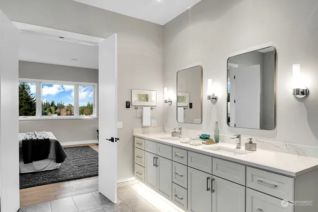 a bathroom with a sink a toilet and mirror