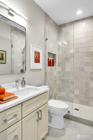 a view of a house with small yard and a large tree