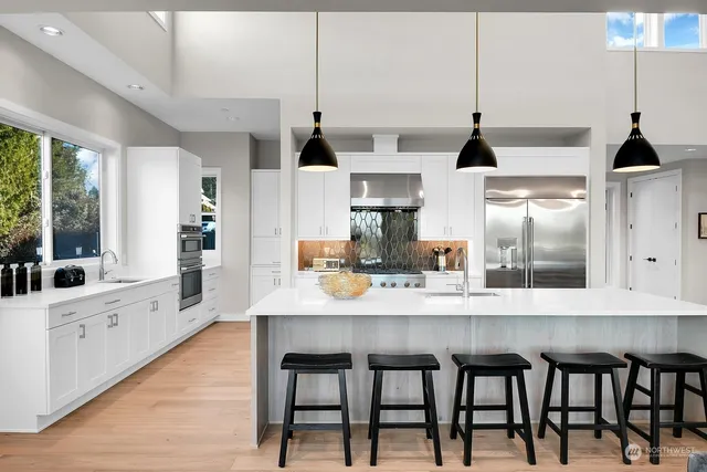 a living room with furniture kitchen view and a wooden floor