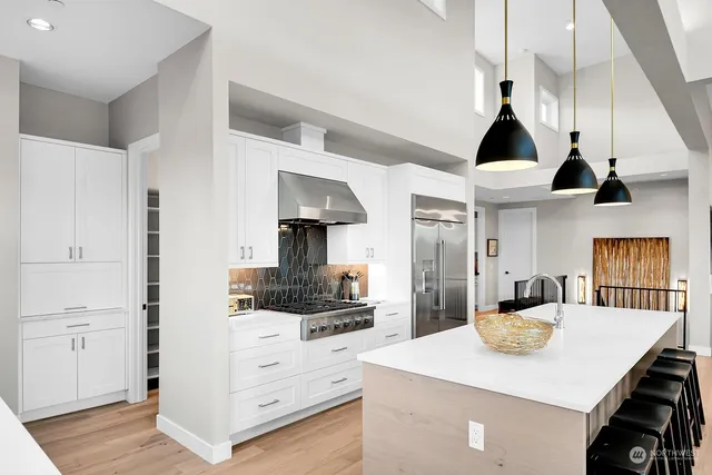 a dining room with stainless steel appliances kitchen island a table and chairs