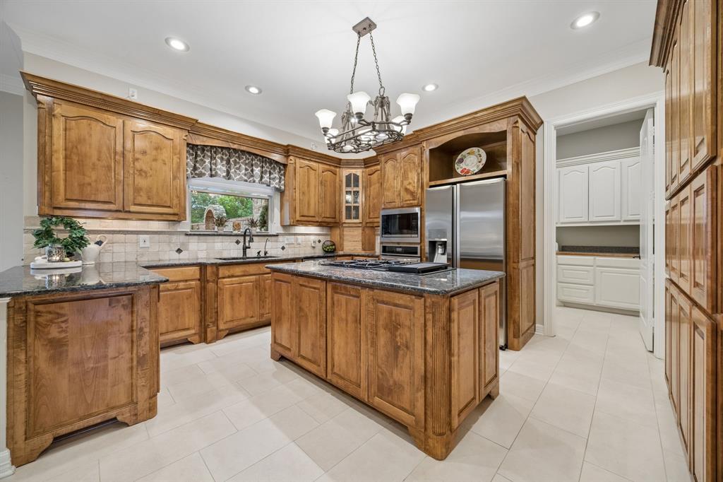 2930 Falcon Way Midlothian, TX 76065 - Photo 12 of 40 a kitchen with stainless steel appliances granite countertop a sink and dishwasher a refrigerator with wooden floor