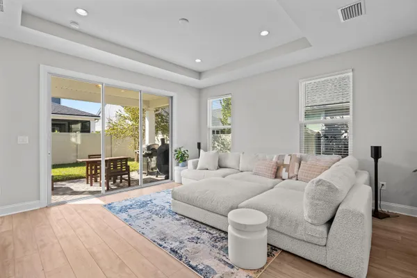 a living room with furniture and wooden floor