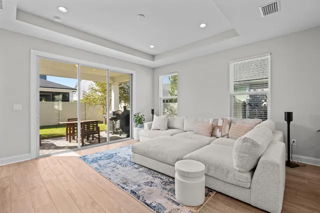 a living room with furniture and wooden floor