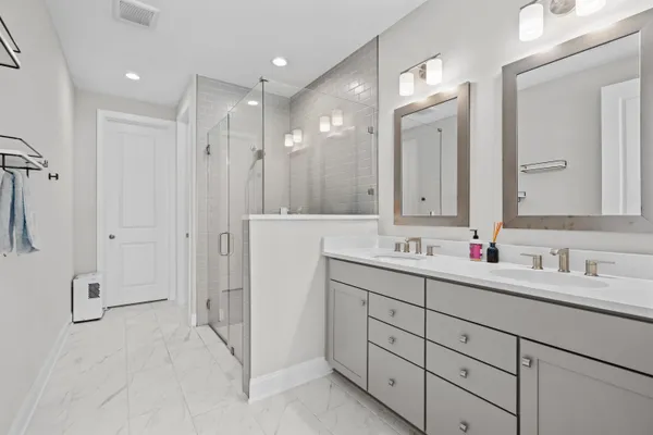 a bathroom with a double vanity sink mirror and
