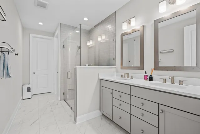 a bathroom with a double vanity sink mirror and