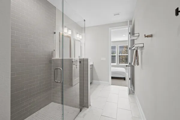 a bathroom with a shower and a glass door
