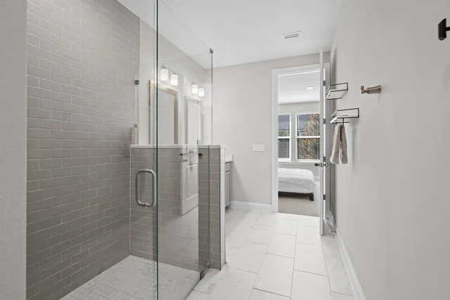 a bathroom with a shower and a glass door