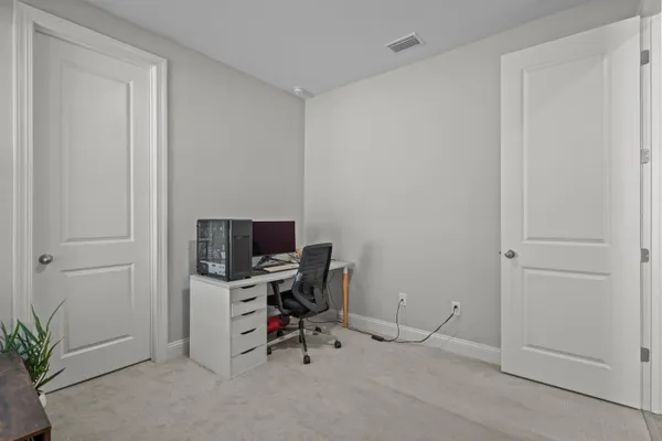 a view of a workspace with furniture