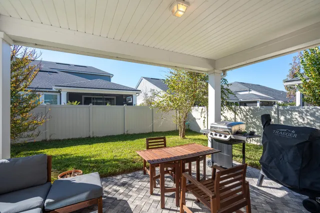 a view of a patio with table and chairs and potted plants