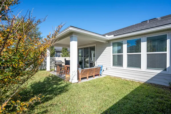 a view of a house with a large window and plants