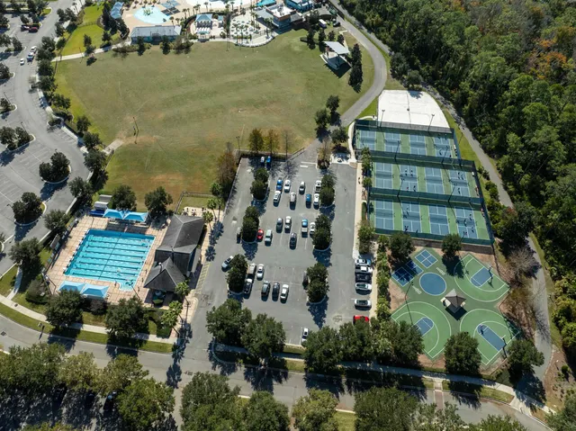 an aerial view of a house with a yard and lake view