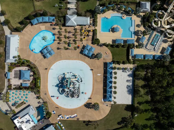 an aerial view of a house with a swimming pool outdoor seating