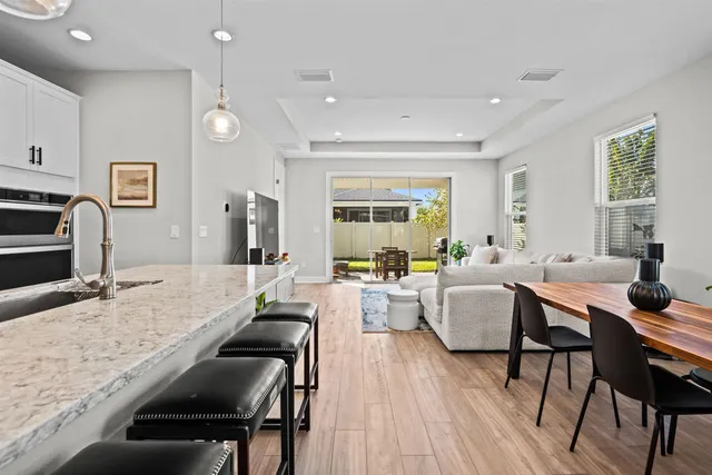 a living room kitchen with a table and chairs