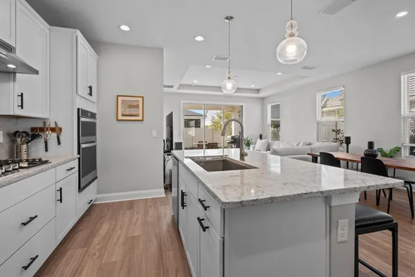a kitchen with center island a sink appliances and cabinets