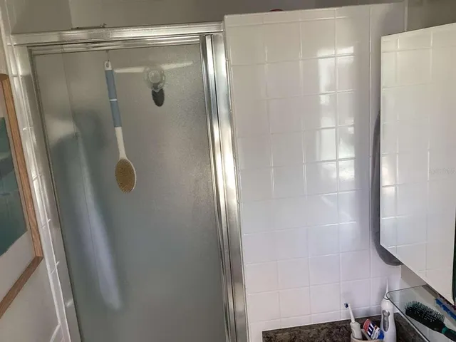 a bathroom with a glass shower door