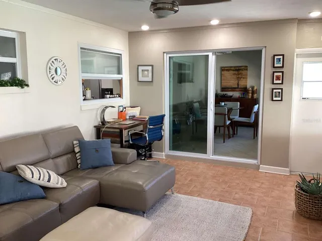 a living room with furniture and a dining table