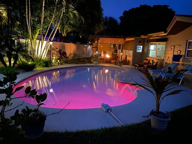 a view of swimming pool with outdoor seating