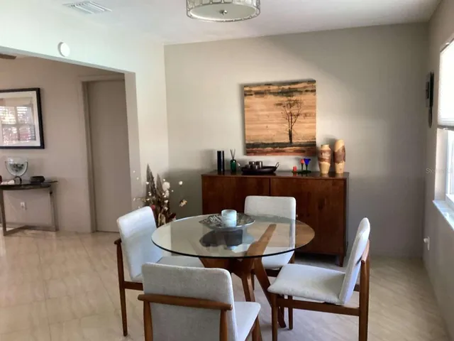 a view of a dining room with furniture and window