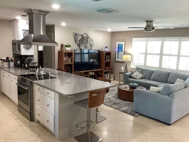 a kitchen with stainless steel appliances granite countertop a sink a stove and a refrigerator