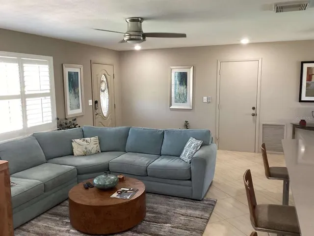 a living room with furniture and a large window