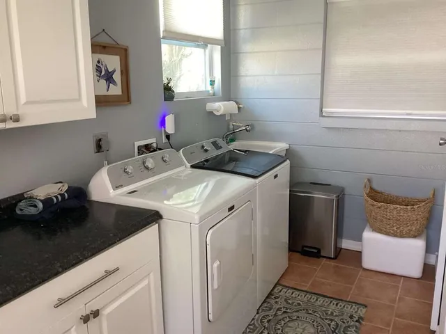 a utility room with sink dryer and washer