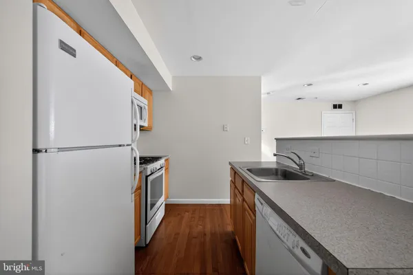 a kitchen with a sink and refrigerator