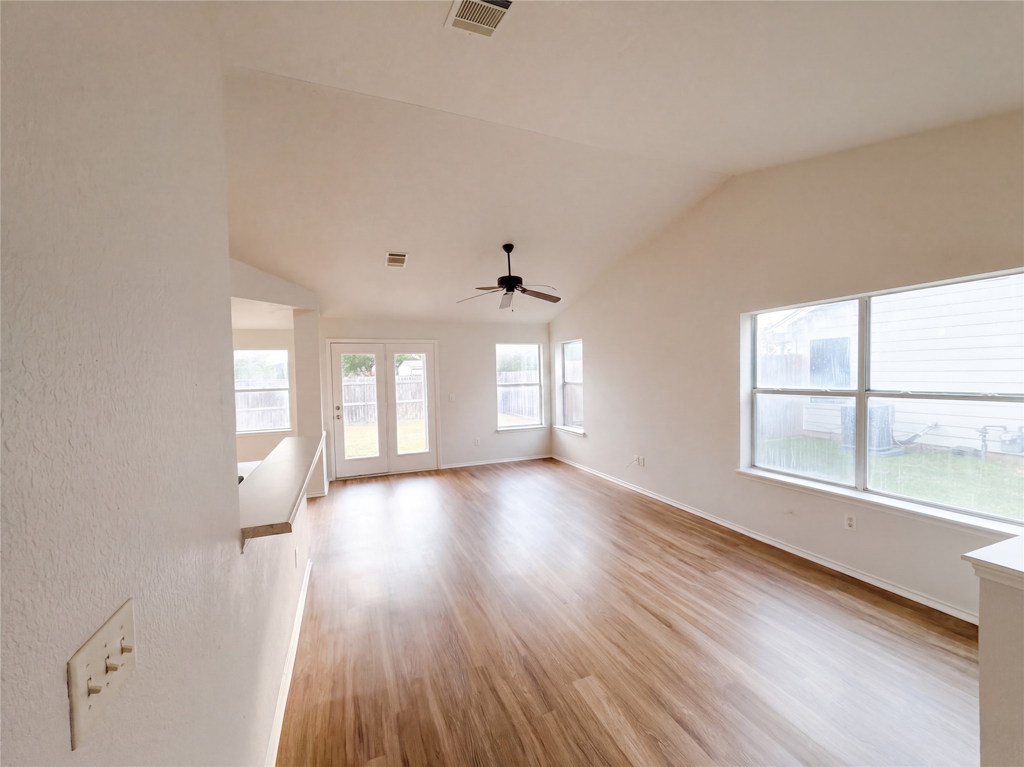 172 Prairie Springs Loop Georgetown, TX 78626 - Photo 26 of 32 Soaring vaulted ceilings and polished wood flooring define this open, airy living space.