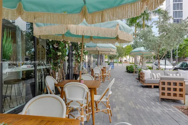 a view of a house with sitting area and potted plants