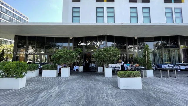 a front view of a house with outdoor seating and plants
