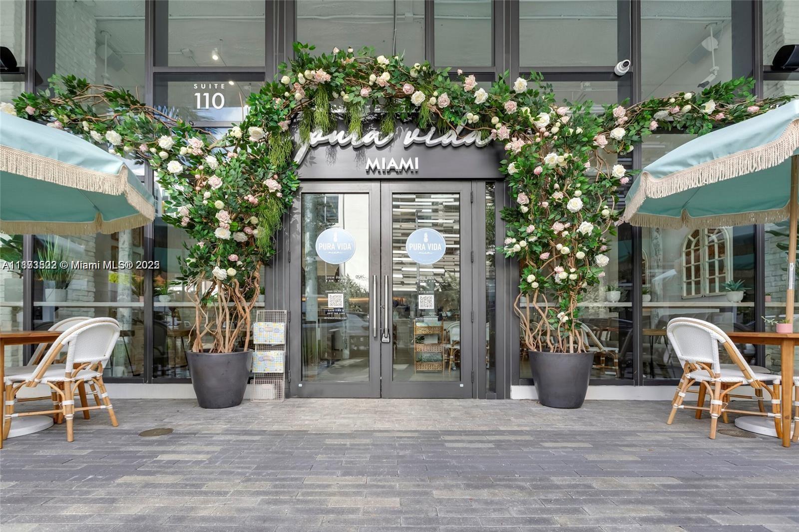 2960 Northeast 207th Street, Unit 1106 Aventura, FL 33180 - Photo 16 of 31 a front view of a house with outdoor seating and plants