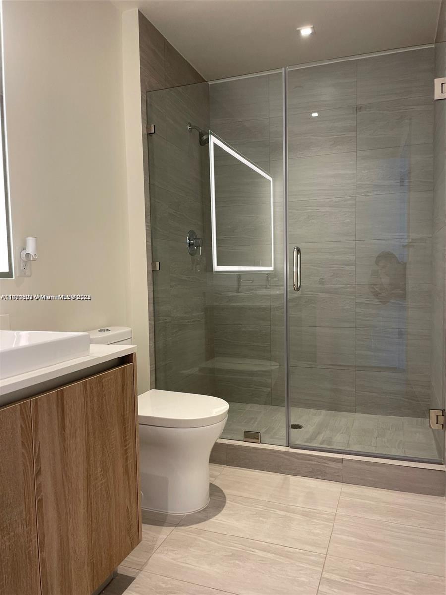 2960 Northeast 207th Street, Unit 1106 Aventura, FL 33180 - Photo 28 of 31 a bathroom with a shower and a toilet