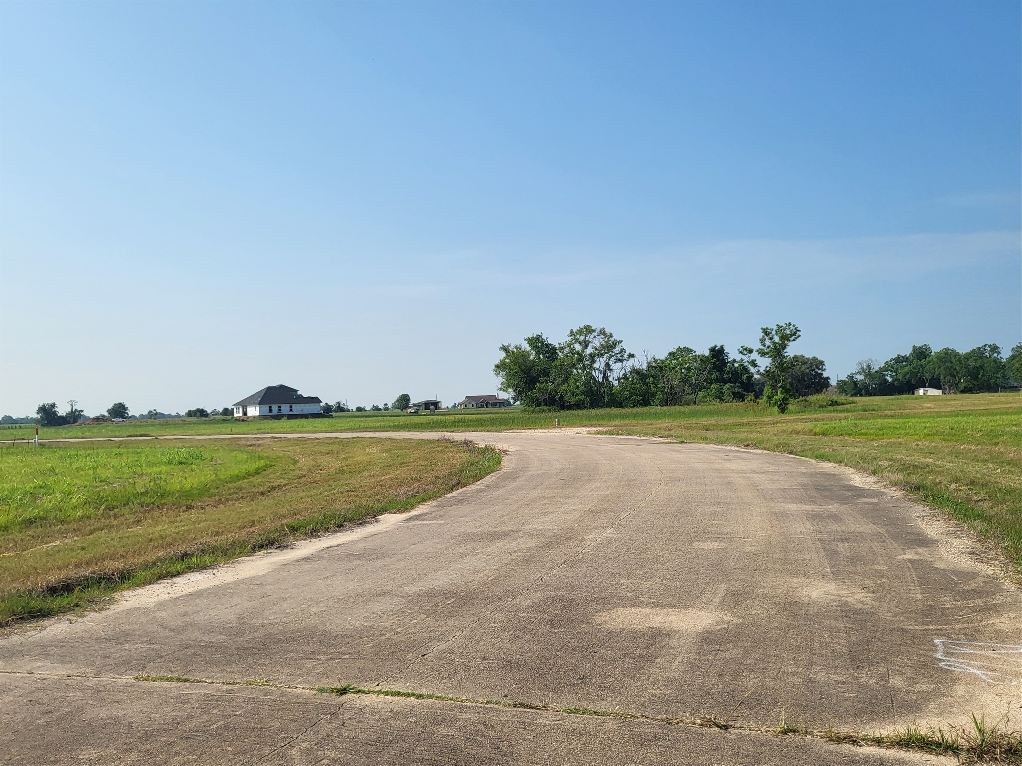 Lot 68 Conestoga Trail Angleton, TX 77515 - Photo 2 of 5 a view of a lake and green valley