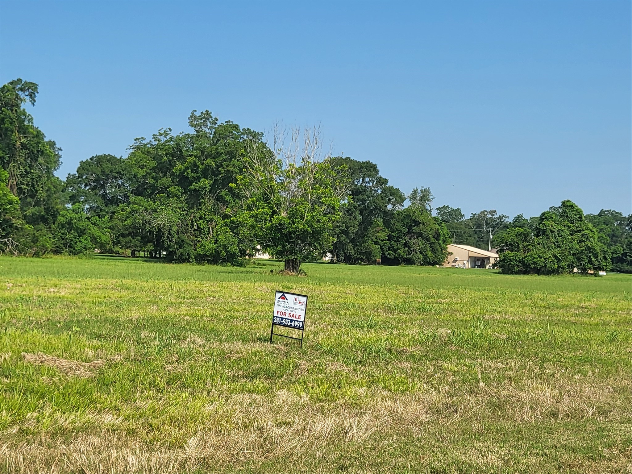 Lot 68 Conestoga Trail Angleton, TX 77515 - Photo 4 of 5 a view of a green field with wooden fence