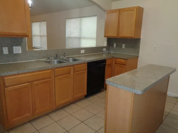 a kitchen with stainless steel appliances granite countertop a sink and a stove