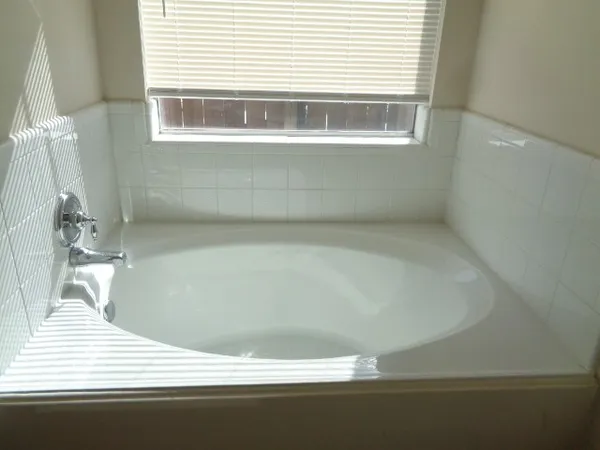 a bathroom with a bathtub and a window