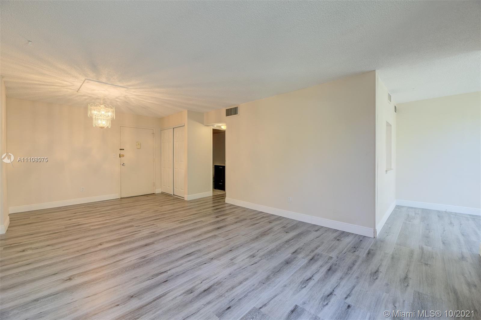 200 172nd Street, Unit 317 Sunny Isles Beach, FL 33160 - Photo 2 of 27 a view of an empty room with wooden floor and a window