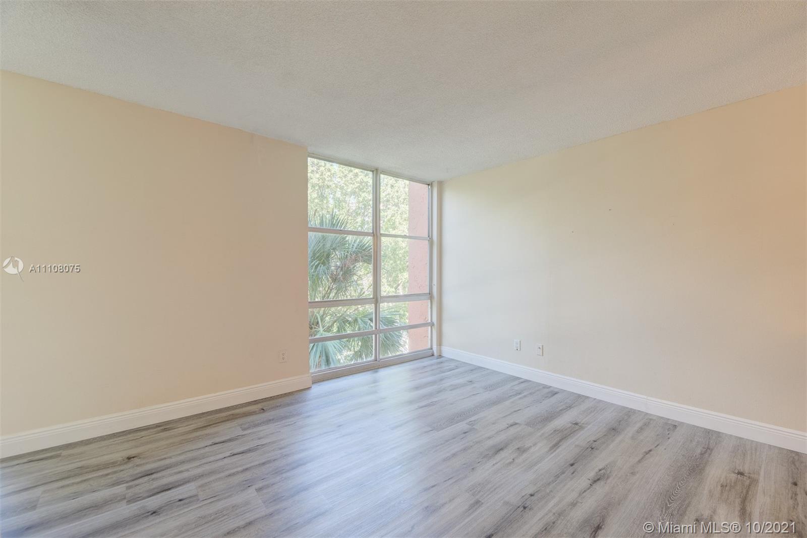200 172nd Street, Unit 317 Sunny Isles Beach, FL 33160 - Photo 14 of 27 a view of an empty room with wooden floor and a window