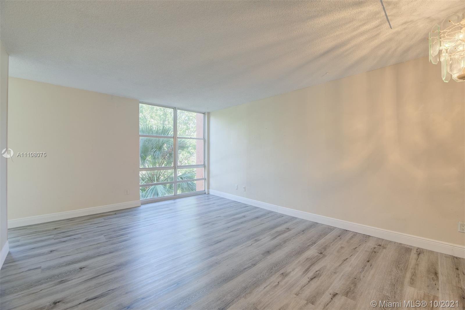 200 172nd Street, Unit 317 Sunny Isles Beach, FL 33160 - Photo 15 of 27 a view of an empty room with wooden floor and a window