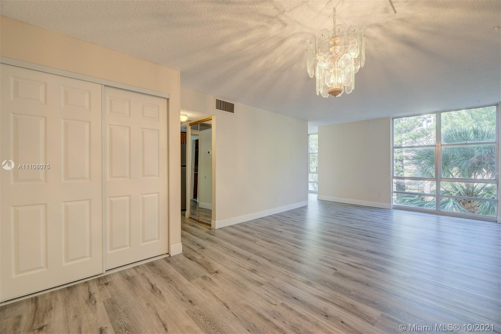 200 172nd Street, Unit 317 Sunny Isles Beach, FL 33160 - Photo 16 of 27 an empty room with wooden floor and windows