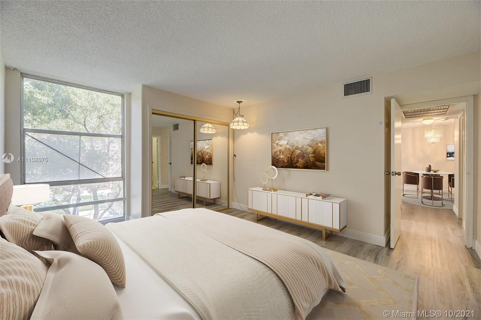 200 172nd Street, Unit 317 Sunny Isles Beach, FL 33160 - Photo 18 of 27 a bedroom with a large bed and a window