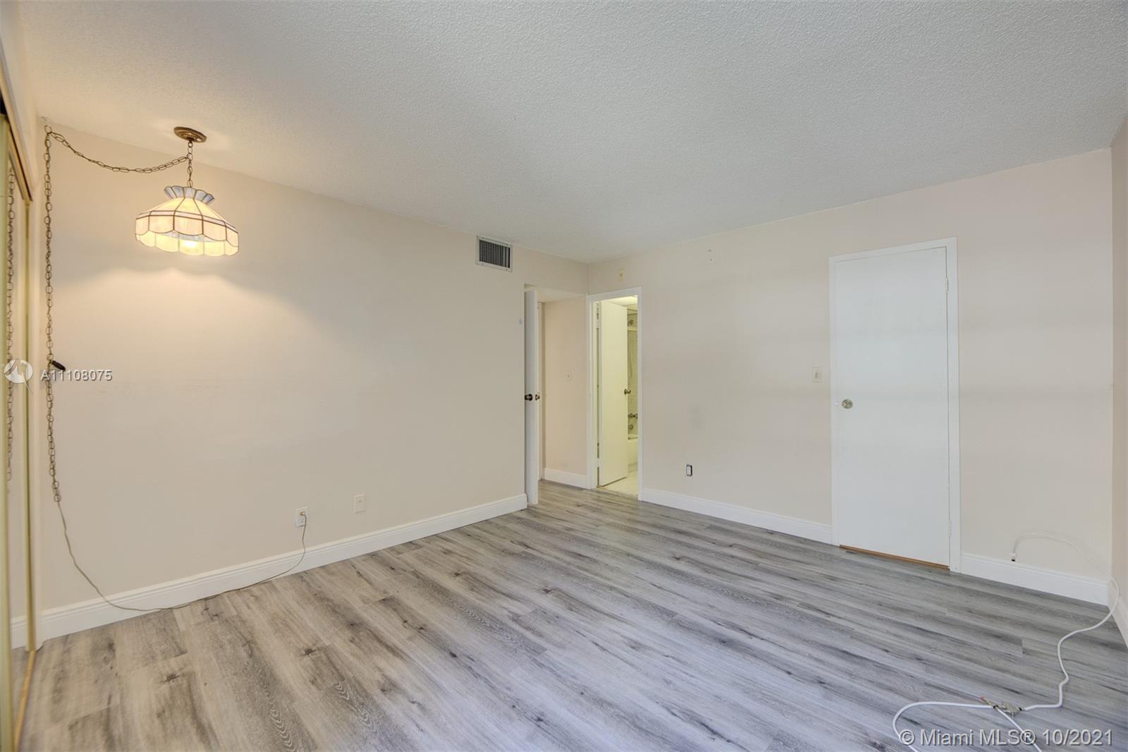 200 172nd Street, Unit 317 Sunny Isles Beach, FL 33160 - Photo 20 of 27 a view of an empty room with wooden floor