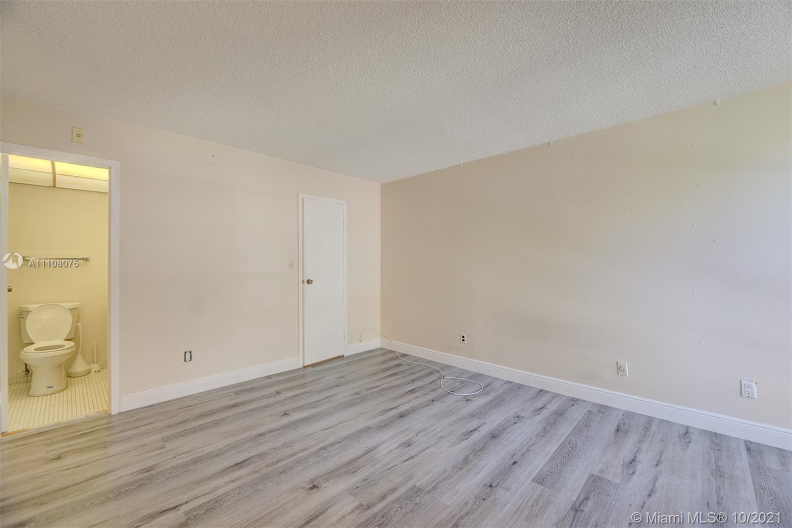 200 172nd Street, Unit 317 Sunny Isles Beach, FL 33160 - Photo 21 of 27 wooden floor in a room