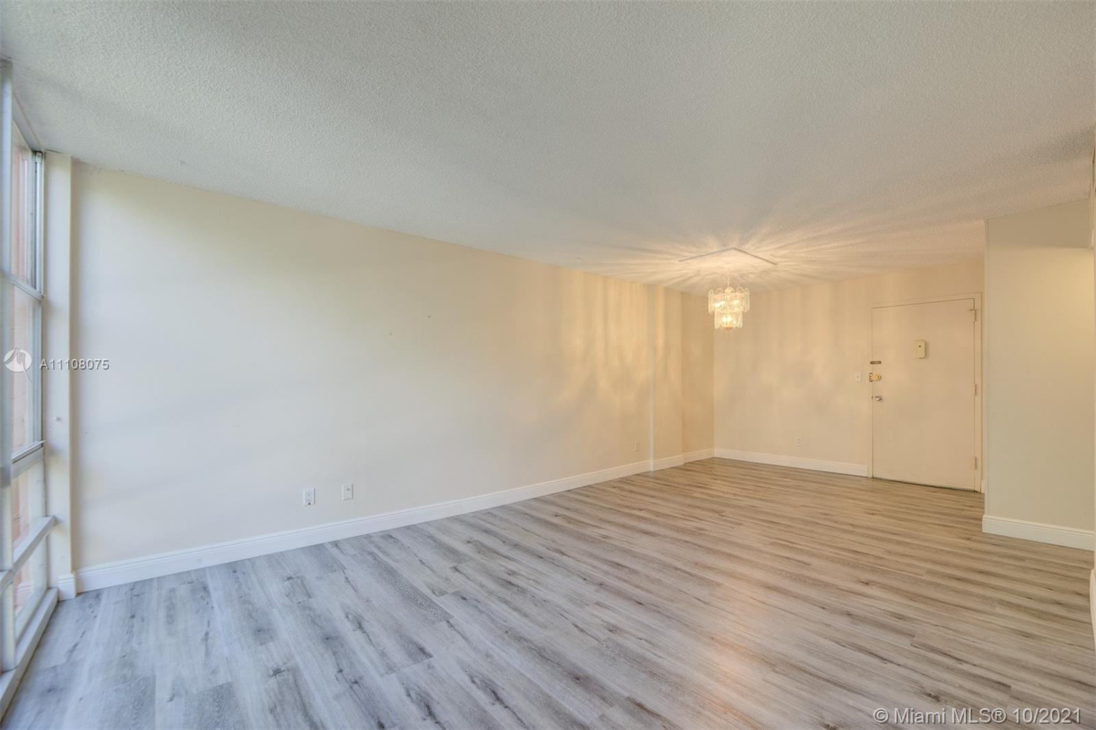 200 172nd Street, Unit 317 Sunny Isles Beach, FL 33160 - Photo 4 of 27 a view of an empty room and wooden floor