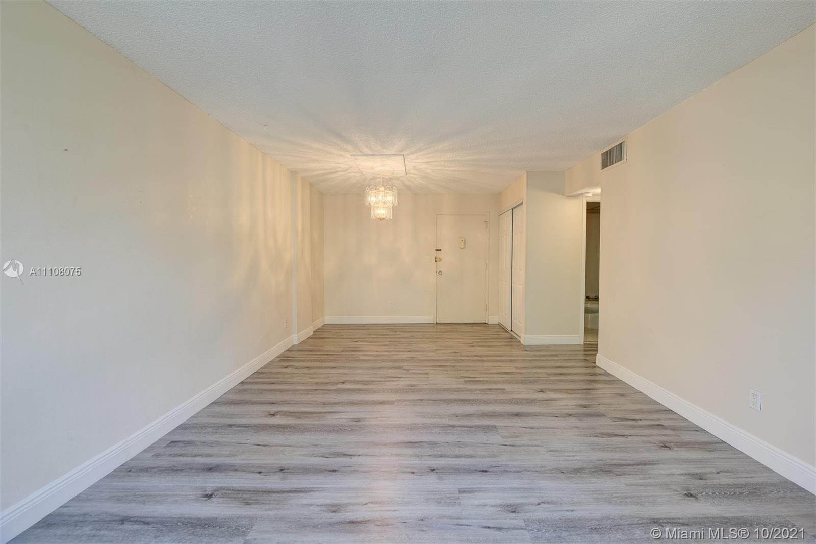 200 172nd Street, Unit 317 Sunny Isles Beach, FL 33160 - Photo 5 of 27 a view of an empty room with wooden floor